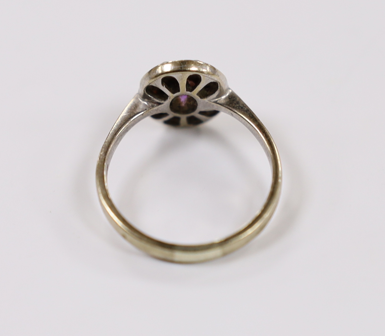 A modern Art Deco style 9ct white gold, amethyst and diamond chip set cluster ring, size Q/R, gross weight 3 grams.